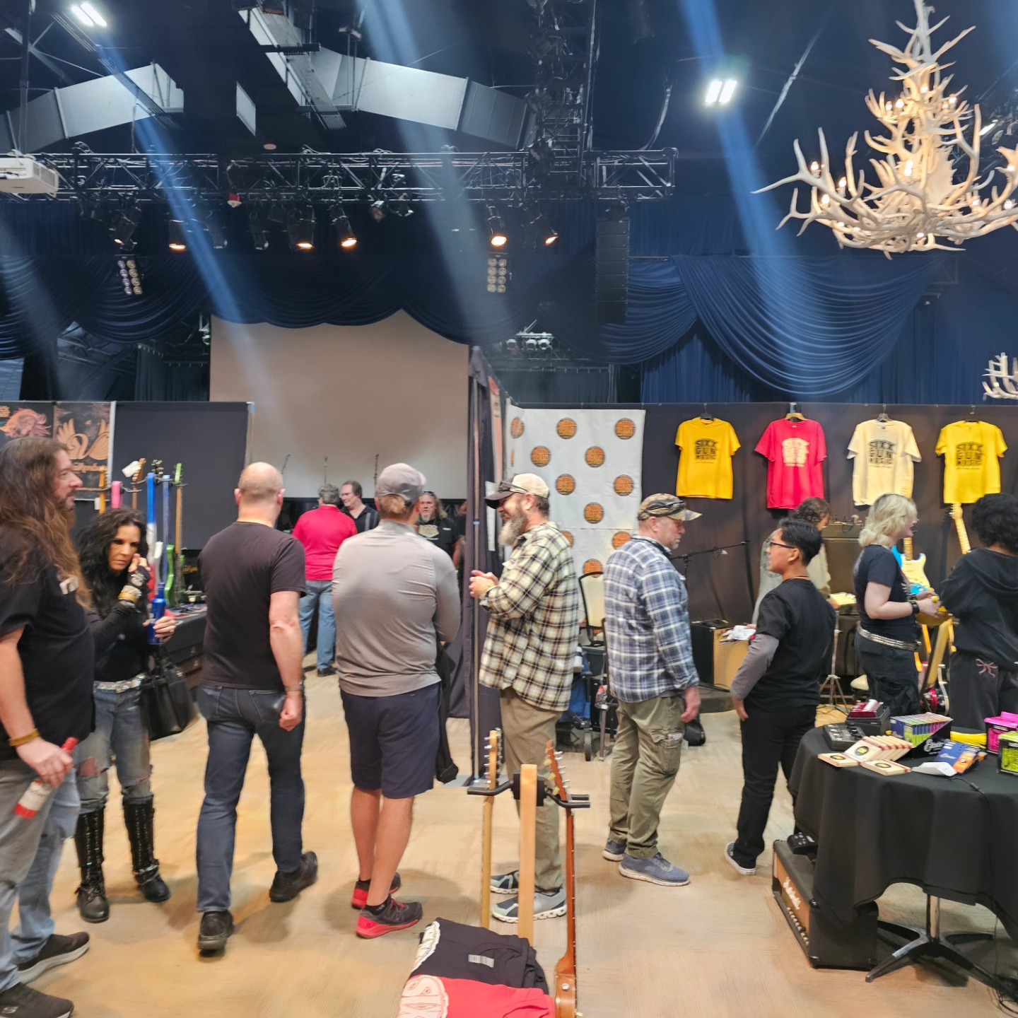 LVGTS attendees and exhibitors mingling on the main floor with stage lighting overhead