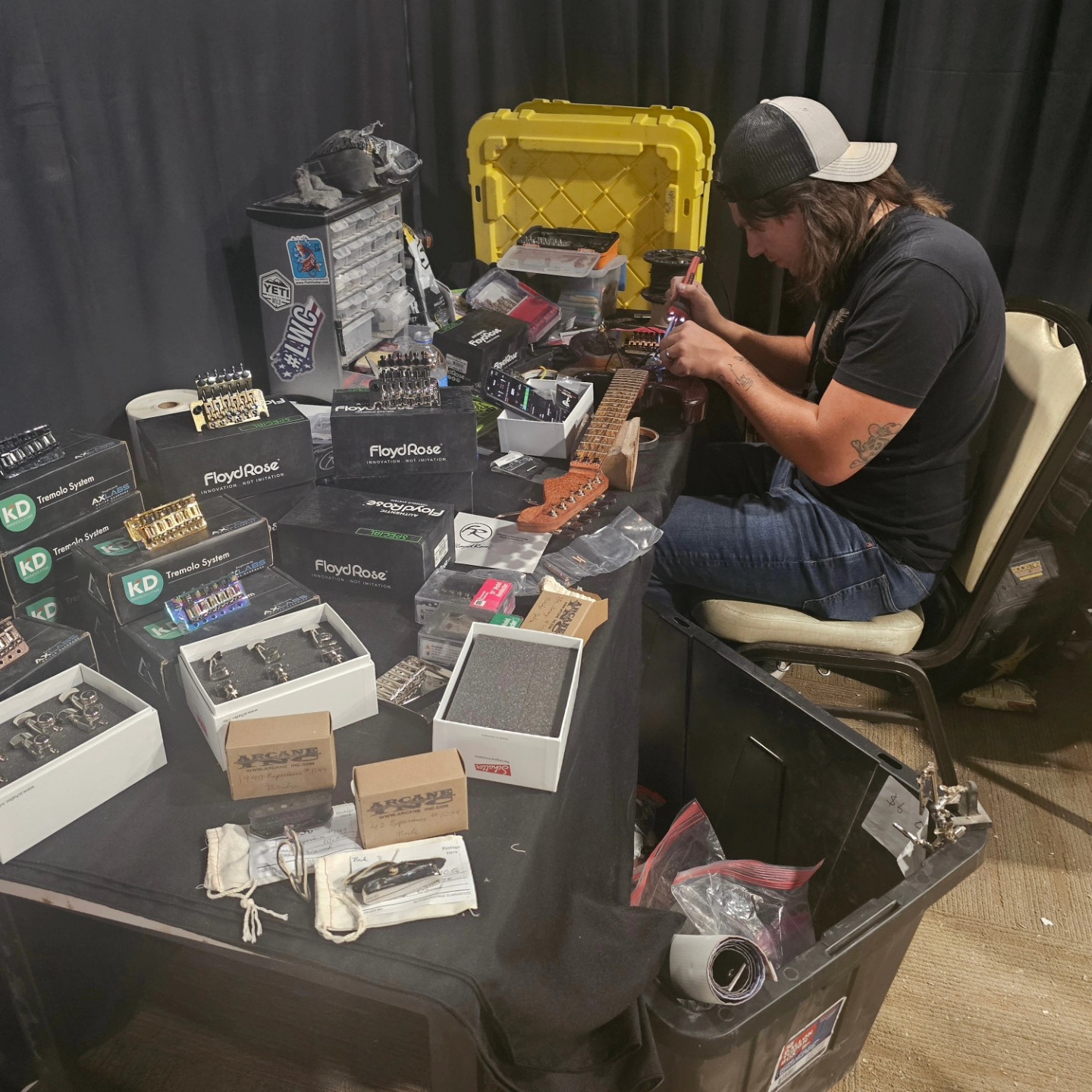 Locke Customs luthier at work — Floyd Rose tremolos and guitar hardware on the LVGTS show floor